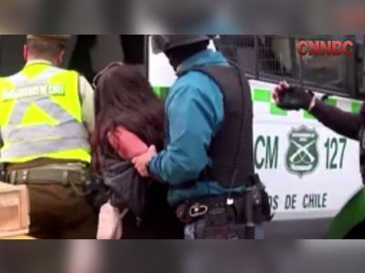 Woman reaches behind and steals gun from a security guard and shoots three people while getting detained in Chile